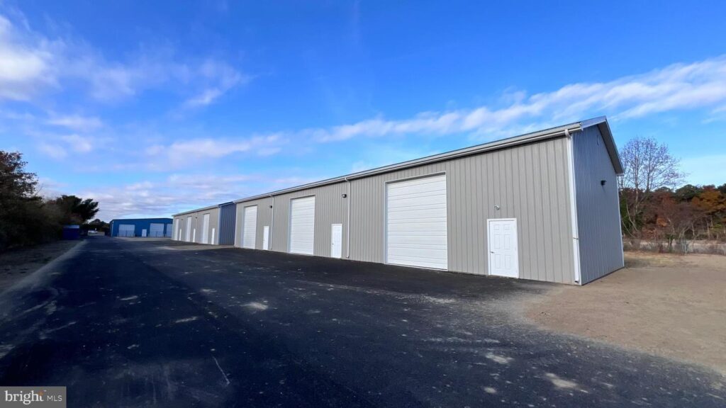 Front view of the commercial property at 16727 Coastal Highway in Lewes, Delaware, featuring a modern exterior, clear signage, and parking area.